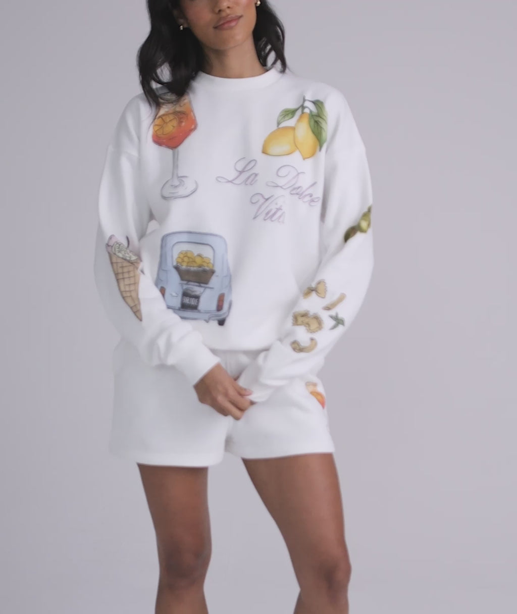 Bride wearing Italy shorts and sweatshirt – honeymoon outfit